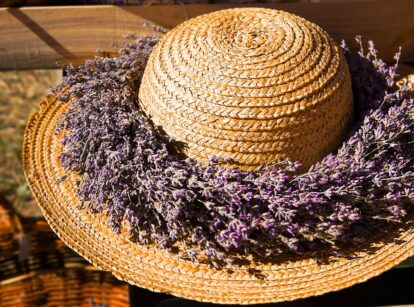 A straw hat adorned with a lavender wreath.