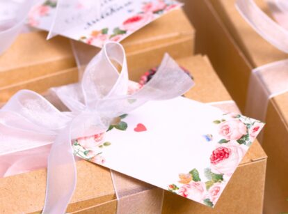 Gift tags adorned with delicate pink flowers and green leaves, each tag has a simple, elegant design.