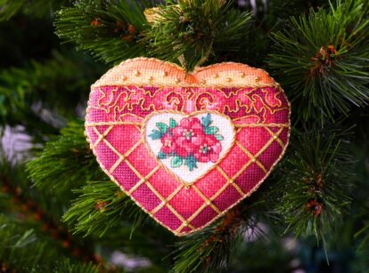 A handmade Christmas ornament, crafted from flower seed bags, hanging on a tree.