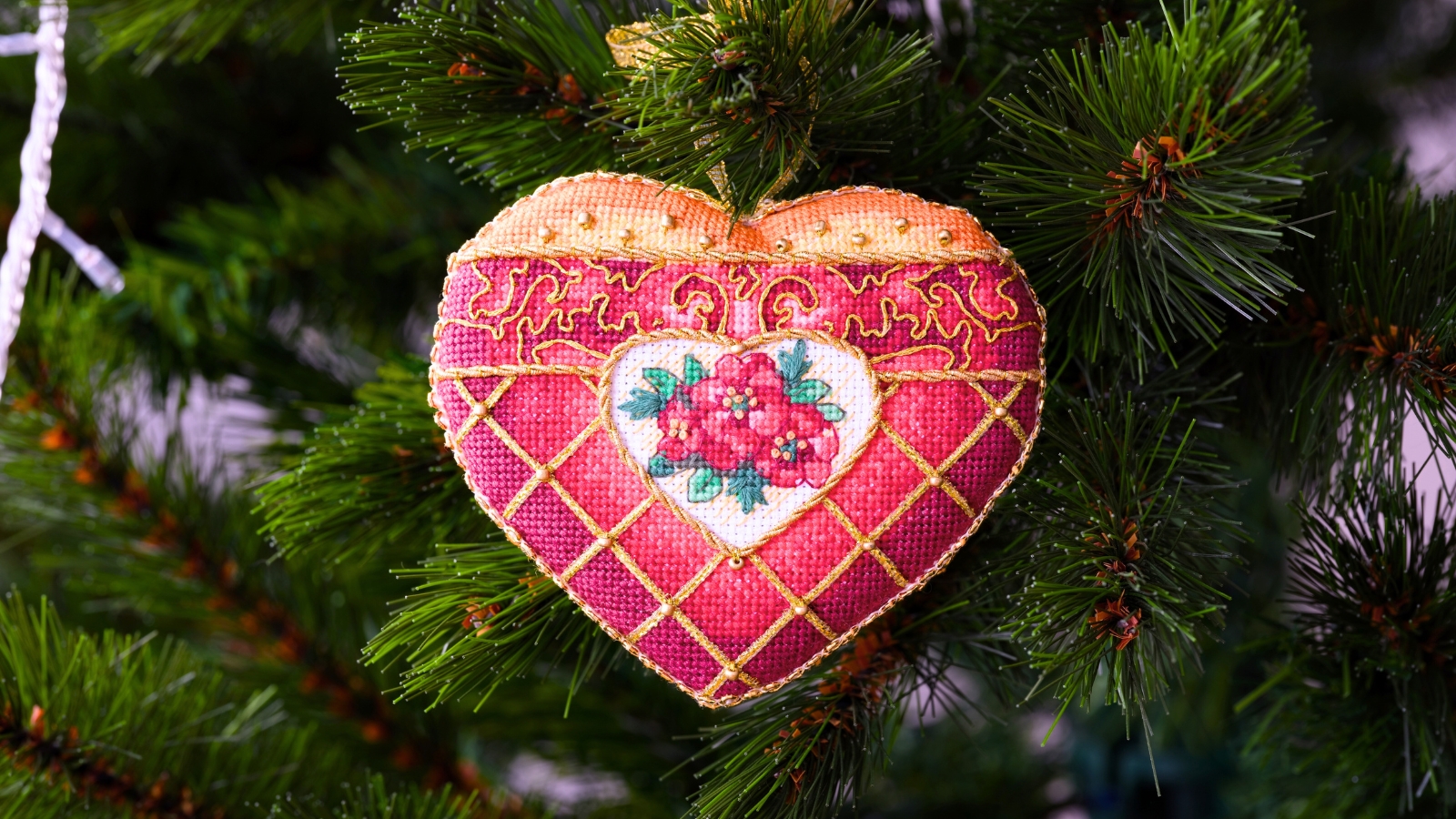 A handmade Christmas ornament, crafted from flower seed bags, hanging on a tree.