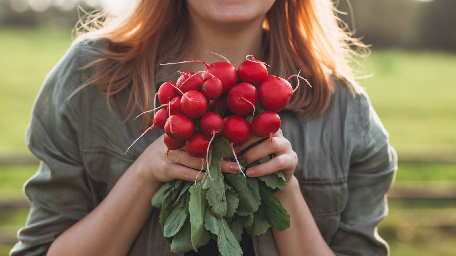 A close-up shot of a person holding fresh crops that shows what to plant vegetables November